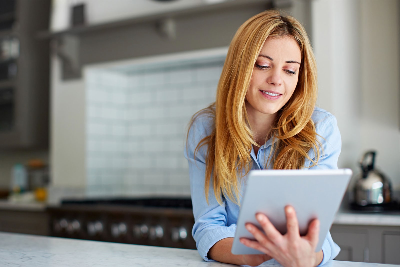 Blonde lady looking at tablet